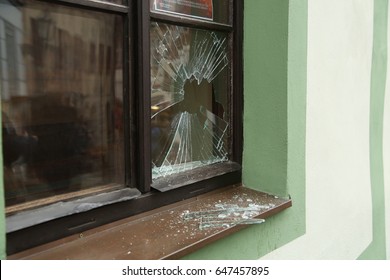 Broken street window and shards of glass