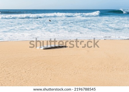 A broken surfboard at the beach