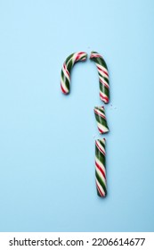 Broken Sweet Christmas Candy Cane On Light Blue Background, Top View