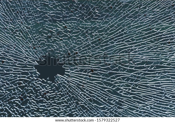 Broken tempered glass, a hole in the window\
glass or car windshield