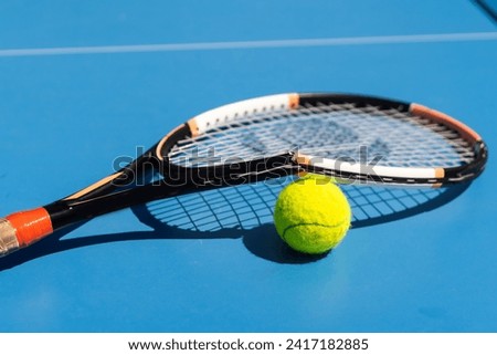 a broken tennis racket blue tennis court.