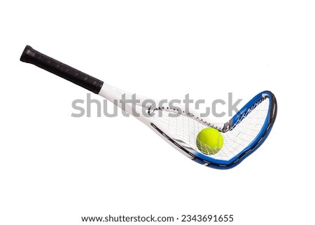 Broken tennis racquet with tennis ball going through the strings on a black background