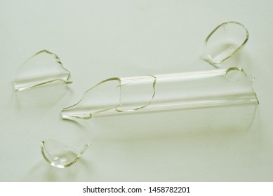 A Broken Test Tube On White Background.