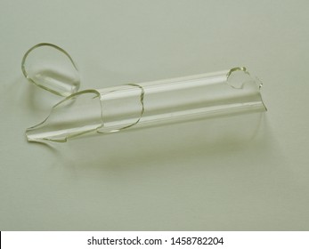 A Broken Test Tube On White Background.