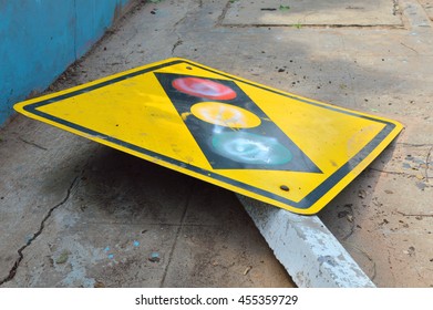 Broken Traffic Light Sign On Footpath Of The Road