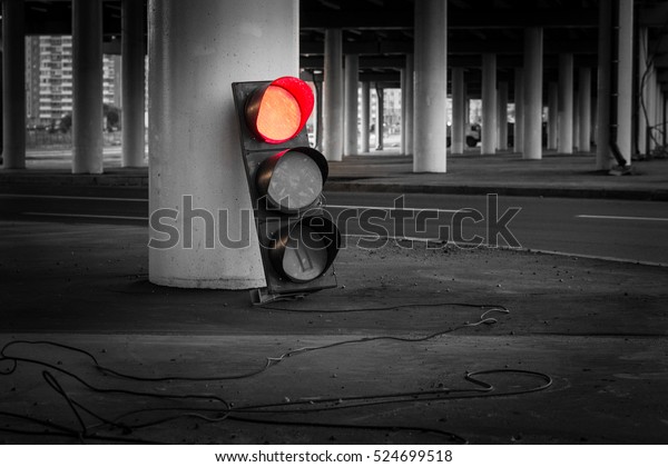 A\
broken traffic signal is the ground and lights up\
red