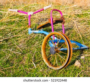 Broken Tricycle Lying On The Ground