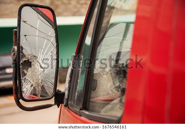 Broken\
truck mirror. Cracked side mirror on an old\
truck