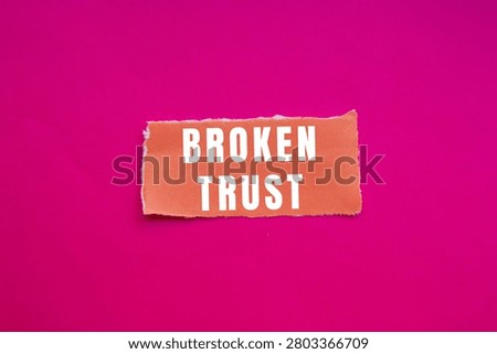 Broken trust concept with text on torn orange paper against a vibrant pink background. Representing betrayal, dishonesty, and hurt in relationships