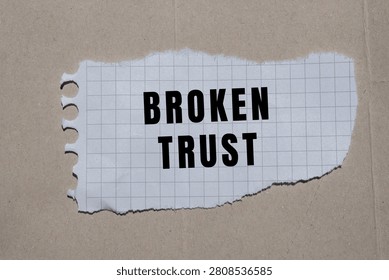Broken trust message on torn grid paper symbolizing betrayal, dishonesty, and a fractured relationship