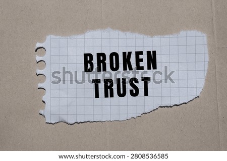 Broken trust message on torn grid paper symbolizing betrayal, dishonesty, and a fractured relationship