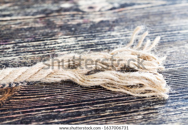 broken and\
untangled thick linen rope, close-up of building materials and\
construction tools at the construction\
site