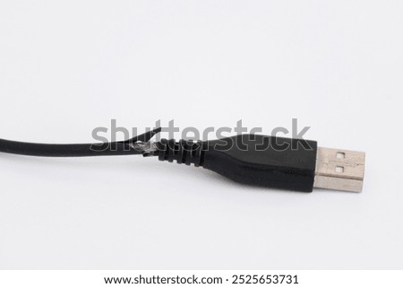 The broken USB charger cable isolated on white background. 
