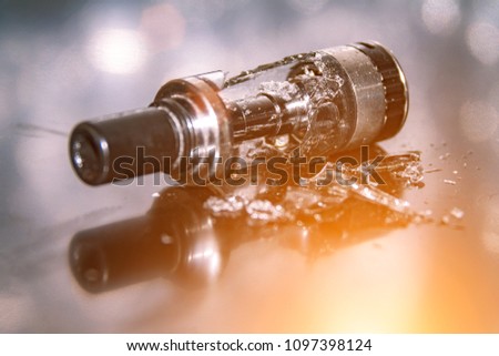 Broken vaping on the table with small pieces of glass. broken glass tank
