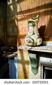 Broken Vase On Mantle Shelf In Dilapidated House