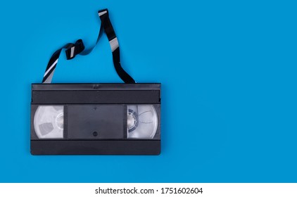 Broken VHS Tape From The 80s And 90s On Blue Background And Space To Write On It