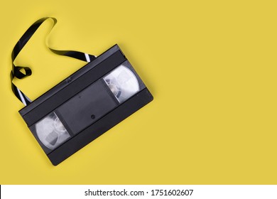 Broken VHS Tape From The 80s And 90s On Yellow Background And Space To Write On It