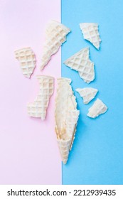 Broken Waffle Cone For Ice Cream On A Pink And Blue Background. Vertical. Top View. Flat Lay.