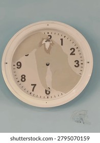 Broken Wall Clock with Missing Hands and Damaged Dial Face.
A damaged white wall clock with missing clock hands and partially peeled dial face, showing deterioration and water damage. The clock face displays visible aging with discoloration and broken glass fragments on the wall below. Concept of broken time, neglect, deadline missed, or the passage of time.