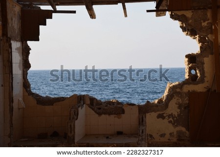 broken wall with sea background, old building , sea view from old derelict building, old wall, fallen wall, empty concept, desolate scene, destruction, empty feeling, desolate building