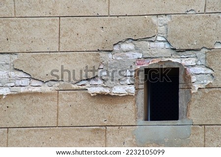                   broken wall with window in a building             