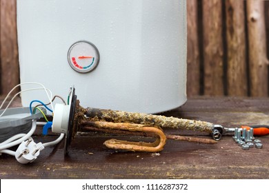 Broken Water Heater With Heating Elements, On Wooden Background.