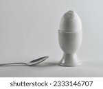 Broken white egg in white egg cup