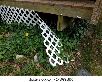 Broken White Lattice Fence On Wood Deck
