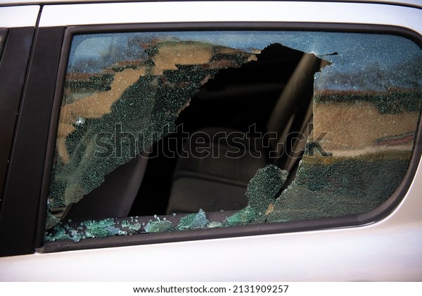 Broken\
window and abduction of things from a car. A criminal incident.\
Hacking the car. Broken left side window of a\
car.