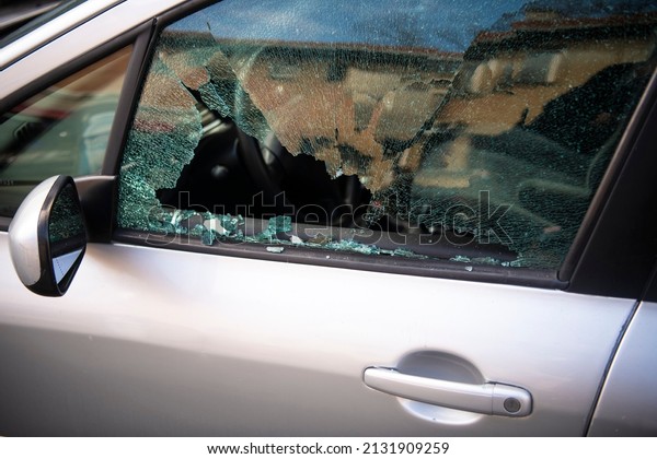 Broken
window and abduction of things from a car. A criminal incident.
Hacking the car. Broken left side window of a
car.