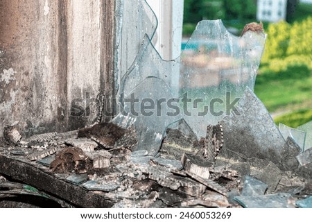 Broken window after explosion. Chaos details after fire disaster