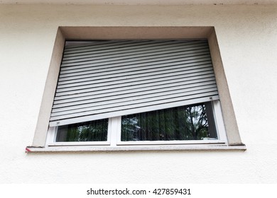 Broken Window Blind At The Window Of An Old Apartment Building