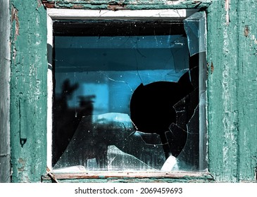 Broken Window. Cracked Glass With Hole. Vandalism, Destruction And Accident Concept