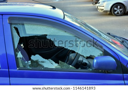 Broken window from driver's side. Attempt to steal bluecar. criminal situation in russian city. 