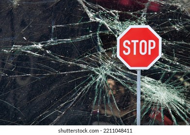 Broken Window Glass With Cracks And Stop Sign, Possible Concept For Bankruptcy Safety Risk And Insurance In Business