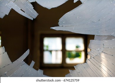 Broken Window Glass looking inside a House with a window background opposite site
