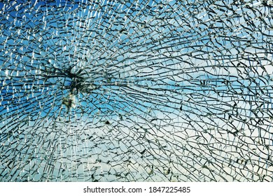 Das zerbrochene Sicherheitslaminat-Glas nach einem Steinwurf zeigt ein rundes Spinnennetzmuster und körnige Stücke, Schutz gegen Gewalt, Aufstände und Vandalismus, Kopienraum, selektiver Fokus