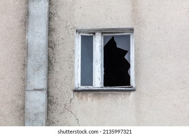 Broken window in the wall of the building as a background.