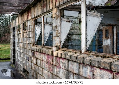 The Broken Windows And Crumbling Brick Of The Abandoned Ruins Of Northern State Mental Hospital In Sedro-Wooley, Washington On A Wet And Dreary Afternoon