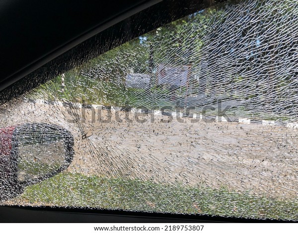 Broken windows glass\
of car cause of accident. Broken glass from accident cause of poor\
seeing for a driver.