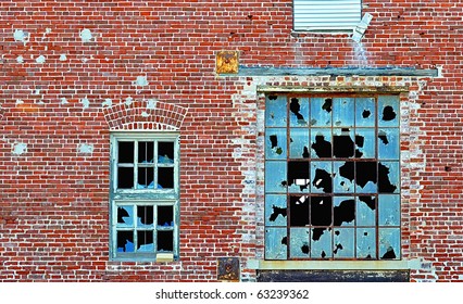 Broken Windows On Side Of Factory