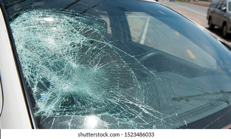 Broken Windscreen or crack windshield of a car in auto service station garage. Broken car windshield, damaged glass. Accident of car. Selective focus