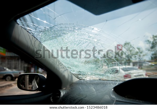 Broken Windscreen or crack windshield of
a car in auto service station garage. Broken car windshield,
damaged glass. Accident of car. Selective
focus