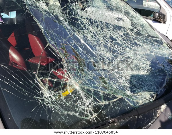 broken\
windshield of abandoned car in the morning\
sun