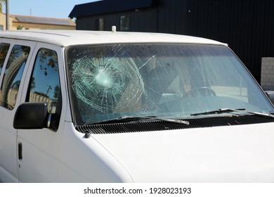 Broken Windshield. A Badly Broken Windshield on an old white panel truck. Broken Windshields are dangerous and illegal to drive with. Window Repair Companies come to you to replace your broken glass.