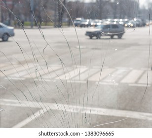 broken windshield of the bus, against the background of the city and street