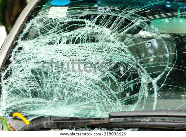broken windshield of car by\
typhoon