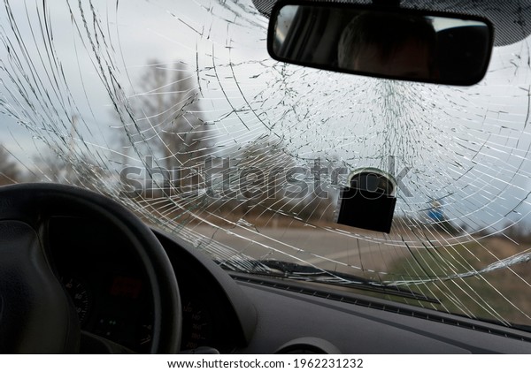 Broken windshield of car\
from inside.