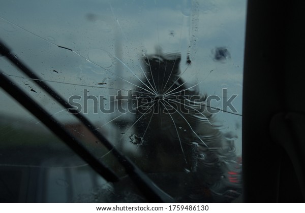 broken\
windshield of a car while driving on the\
road