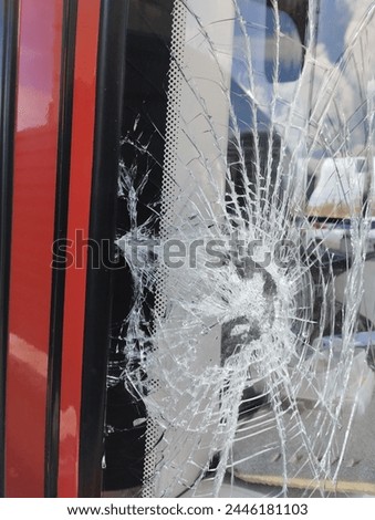 broken windshield of a city bus during a traffic accident